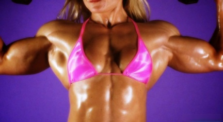 Blonde bodybuilder Brigita Brezovac pumps iron while wearing a pink bikini 75943034