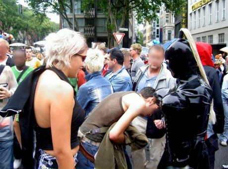 Candid action of latex enthusiasts taking part in a parade 35806944